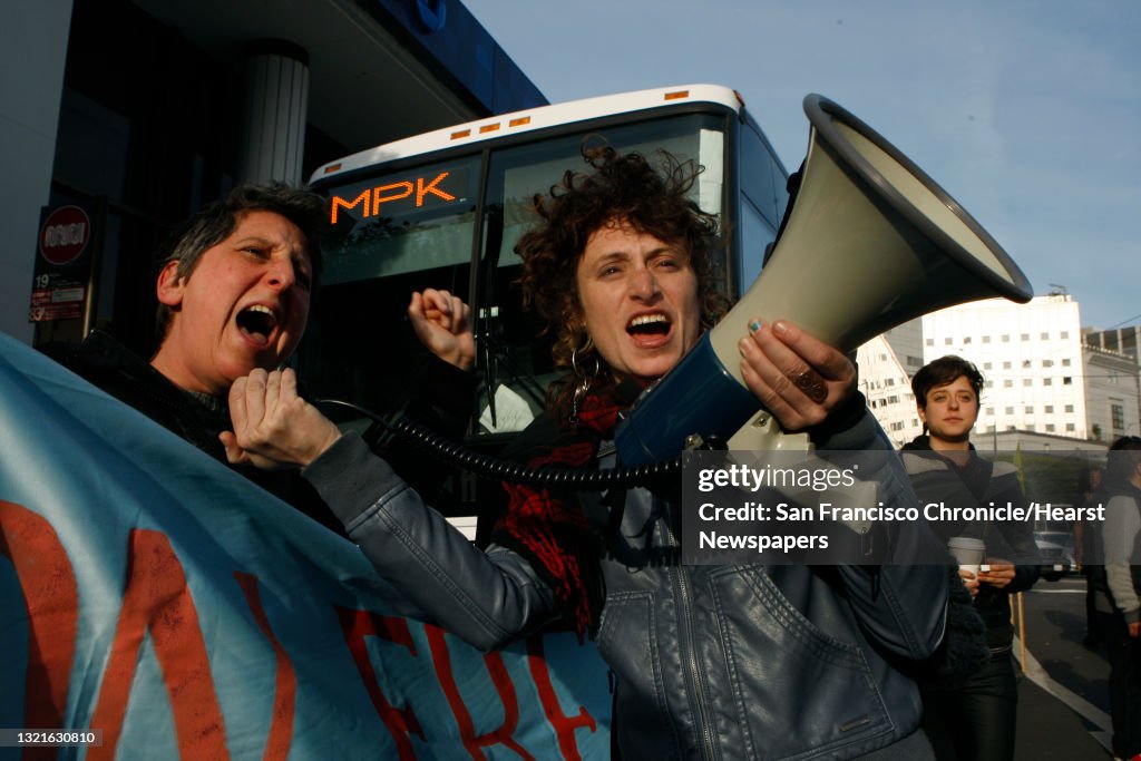 Sara Shortt (left) from the Housing Rights committee of San Francisco and activist Erin McElroy (right) block a Facebook bus heading to Menlo Park on 8th at Market streets in San Francisco, Calif., on Tuesday, January 22, 2014. The San Francisco Metropol