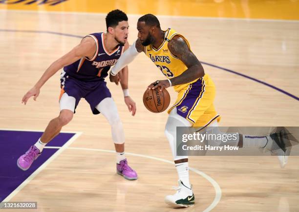 LeBron James of the Los Angeles Lakers drives on Devin Booker of the Phoenix Suns in the fourth quarter during game six of the Western Conference...
