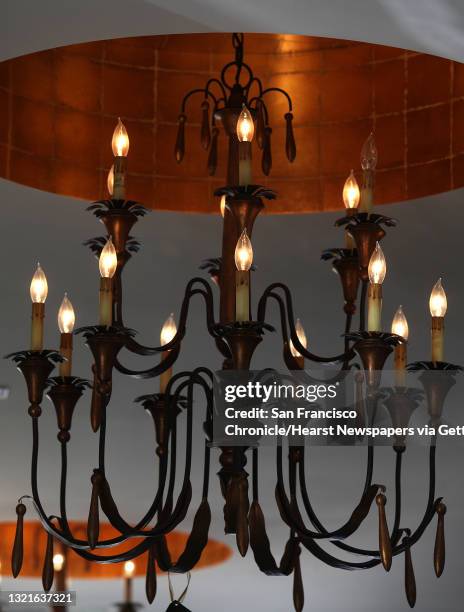 Large Parisienne chandeliers in rust/gold leaf priced at $1800 on display at Blair Morgan's design studio in Menlo Park, California, on Thursday,...