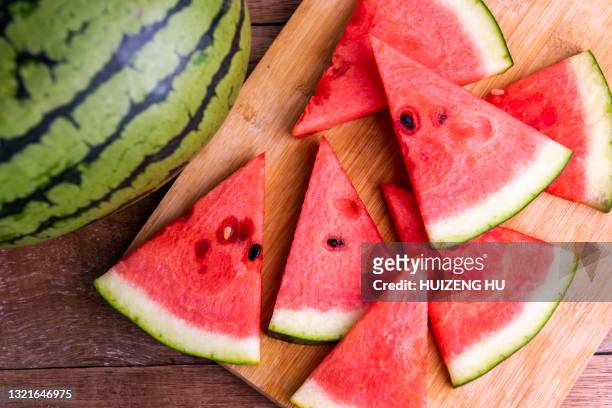 fresh ripe watermelon slices on wooden table. - watermelon fotografías e imágenes de stock