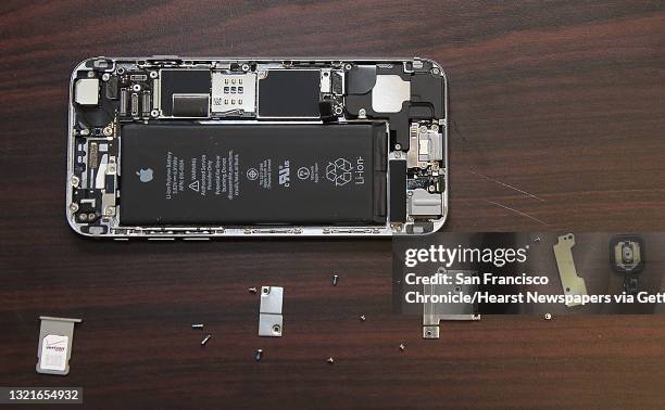 Dish employee Johnson Chuong takes apart an iPhone to fix a cracked screen on site in the Chronicle building in San Francisco, California, on...