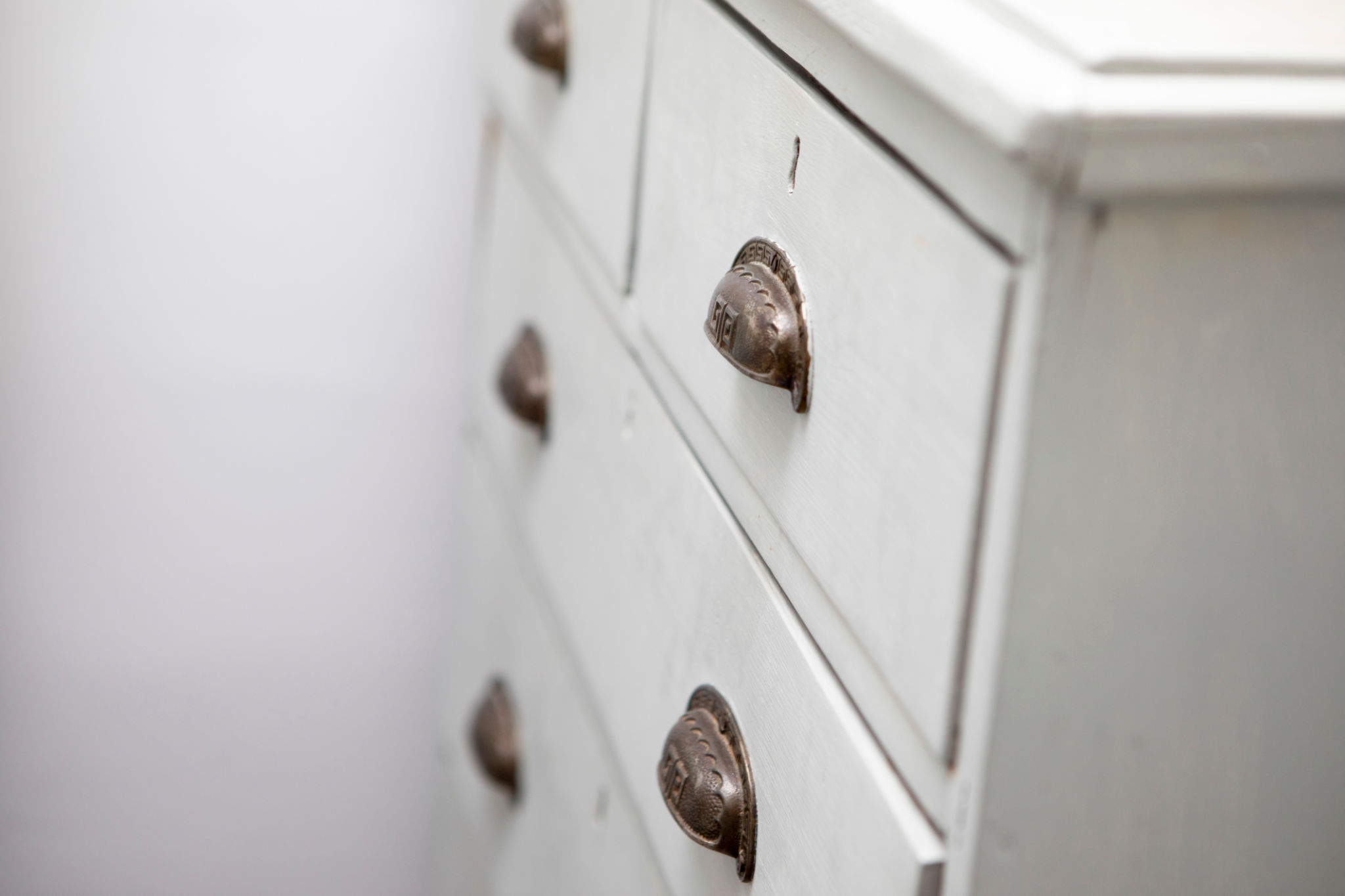 Old wooden chest of drawers with metal handles Old wooden chest of drawers with metal handles