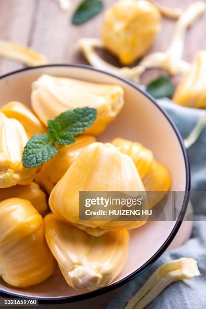 fresh jackfruit on wooden table - jackfruit foto e immagini stock