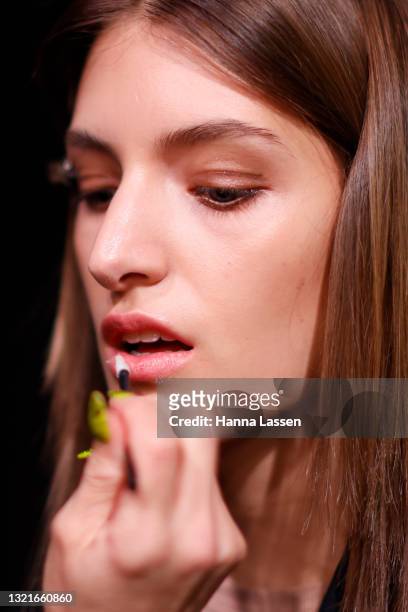 Model prepares backstage ahead of the Christopher Esber show during Afterpay Australian Fashion Week 2021 Resort '22 Collections at Carriageworks on...