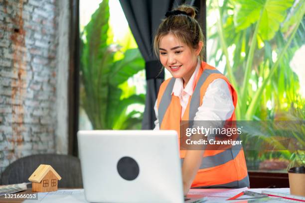 the young woman interior architect or interior designer working on home design at a office  room. - construction worker office people stock-fotos und bilder