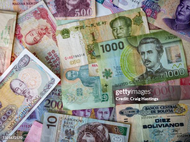colorful selection of foreign fiat bank notes from around the world - abwertung stock-fotos und bilder