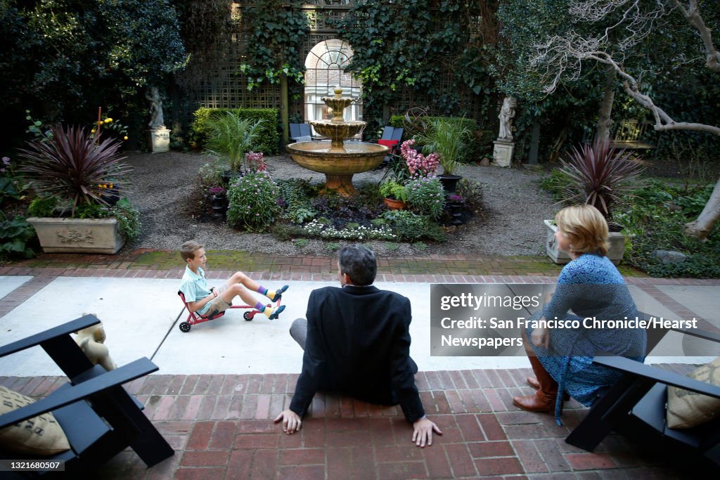 Chad Olcott and his wife Laura Pochop, owners of Mulberry's Market in Piedmont, Calif., chat on the front stairs of their home while their son Charlie Olcott, 10 years old, passes by on Thursday, January 29, 2015.