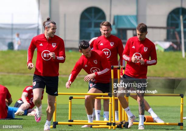 Gareth Bales, Aaron Ramsey and Kieffer Moore warm up during the Wales squad training session on June 04, 2021 in Vale of Glamorgan, Wales, United...