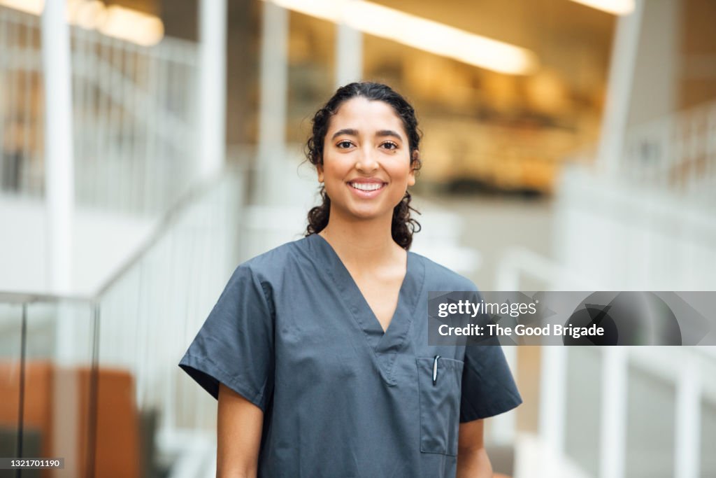Portrait of smiling nurse standing in hospital