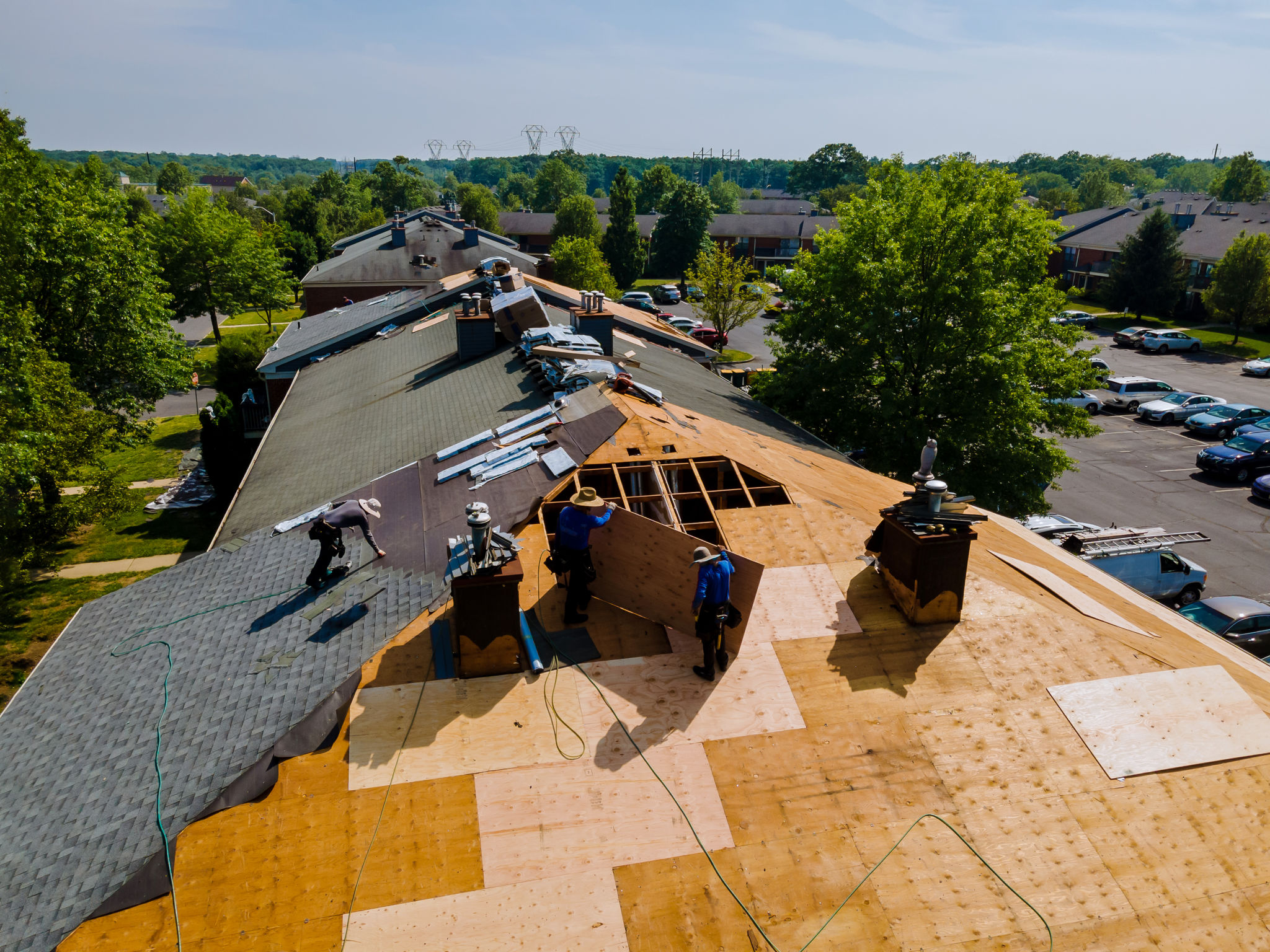 Roof shingles need with new shingles of an apartment building replacing gray asphalt tile Roof shingles need with new shingles of an apartment building replacing gray asphalt tile