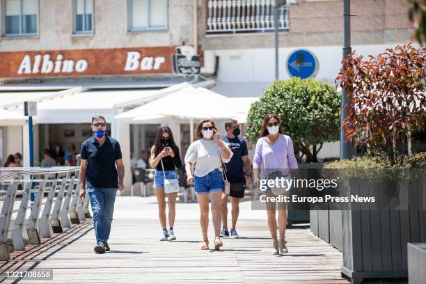 Several people on the promenade of the beach of Sanxenxo, on 4 June, 2021 in Sanxenxo, Pontevedra, Galicia, Spain. The increasing temperatures and...