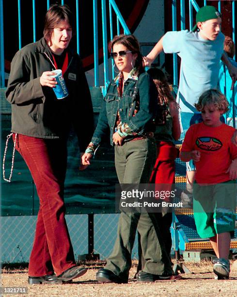 Lisa Marie Presley spends an afternoon with her fiance musician John Oszajca and her children Danielle and Benjamin at a carnival October 2000 in...