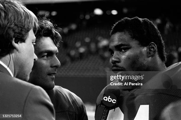 Quarterback Doug Flutie and Running Back Herschel Walker of the New Jersey Generals are interviewed after the game between the Los Angeles Express vs...