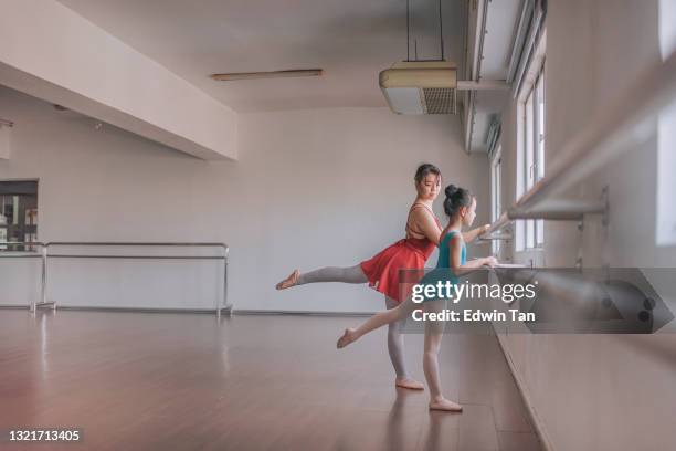 asian chinese teenage girl ballet dancer training her young girl student in the studio - kids in undies stock pictures, royalty-free photos & images
