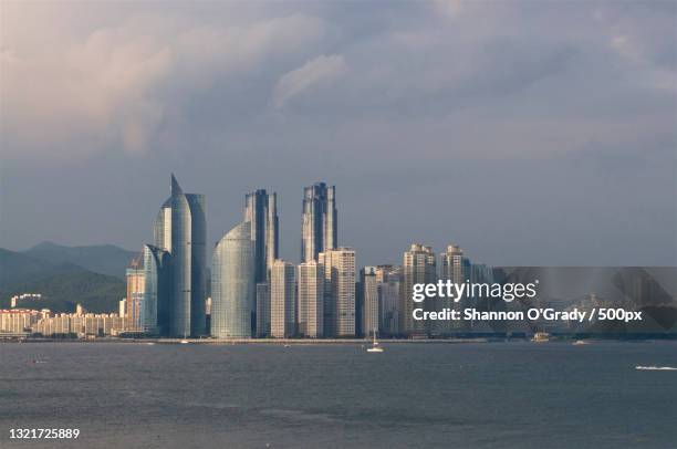 view of buildings in city against cloudy sky,busan,south korea - busan stock pictures, royalty-free photos & images