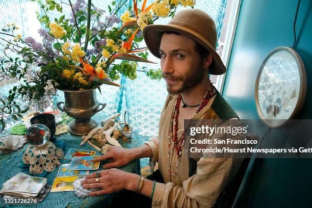 Hangedman Company owner Matthew Drewry reads tarot cards and is a wild floral arranger at MacArthur Annex, a retail complex of 24 shipping containers...