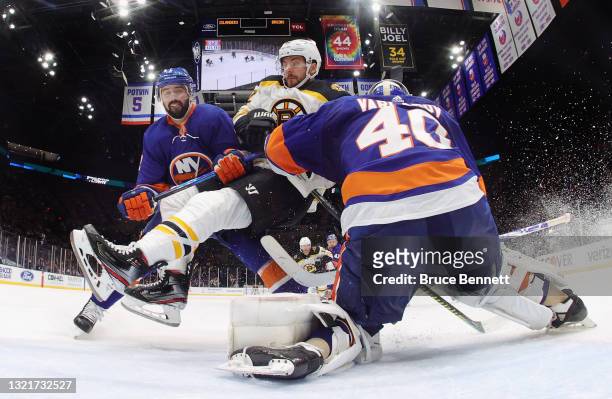 Nick Leddy and Semyon Varlamov of the New York Islanders defend against Sean Kuraly of the Boston Bruins in Game Three of the Second Round of the...
