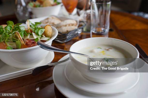 close-up of fresh food served on table in restaurant - scodella per zuppa foto e immagini stock