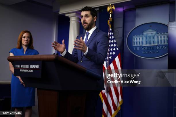 National Economic Council Director Brian Deese speaks as White House Press Secretary Jen Psaki looks on during a daily press briefing at the James...