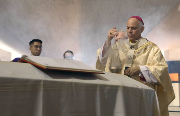 Archbishop of San Francisco, the Most Reverend Salvatore J. Cordileone leads the prayer of commendation during the funeral Mass of archbishop...
