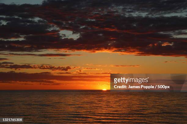 scenic view of sea against dramatic sky during sunset,glenelg south,south australia,australia - james popple stock pictures, royalty-free photos & images