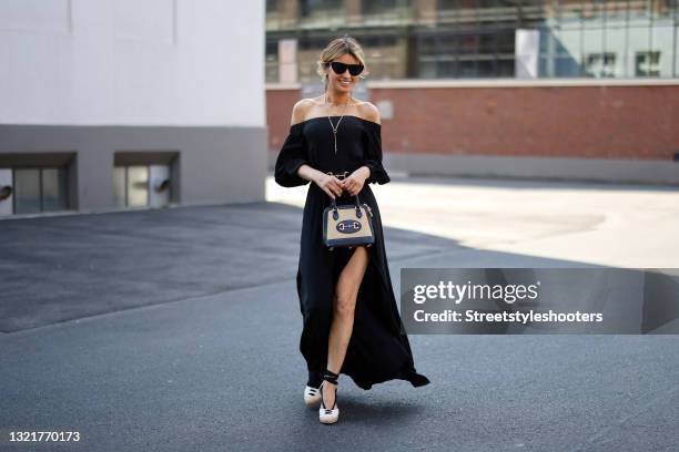 Influencer Gitta Banko wearing an elegant black off shoulder maxi dress "u2018gabino"u2019 with leg slits by Nicowa, beige and black wedges by...