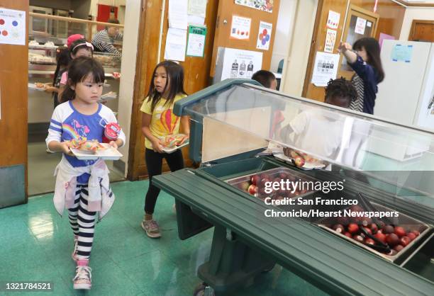 First grade student Ky Vuong , gets her lunch in the cafeteria at Franklin Elementary school on Friday, Sept. 7 in Oakland, Calif. The after school...