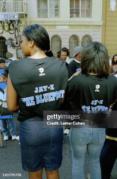 Fans of American rapper, songwriter, record executive, businessman, and media proprietor Jay-Z stand in the street as he promotes his sixth studio...