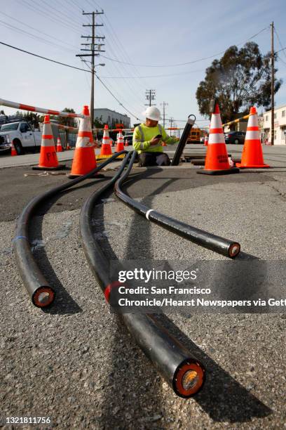 Zach Braun with Pinnacle Power helps to install P. G. And E. Power lines underground along Old Country Rd. Near Harbor Way, with plans on removing...