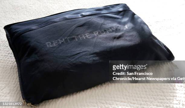The fashion items arrive by mail in a garment bag at the home of Mary Doyle on Fri. March 18 in San Francisco, California. Doyle has been using Rent...
