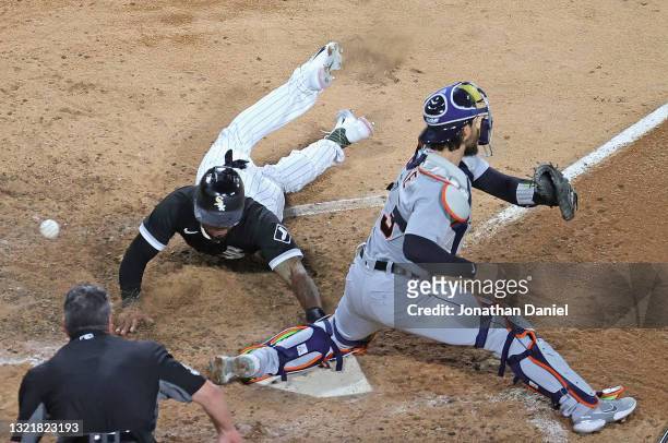 Leury Garcia of the Chicago White Sox scores a run in the 5th inning as Eric Haase of the Detroit Tigers misses the throw at Guaranteed Rate Field on...