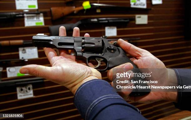 Customer displays the hand giuun he had purchased from Todd Settergren of Setterarms gun shop, on Friday Jan. 13 in Walnut Creek, Ca. Gun shop owner,...