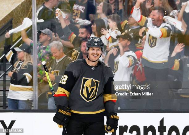 Vegas Golden Knights fans celebrate as Nick Holden of the Vegas Golden Knights smiles after assisting Max Pacioretty on a third-period goal against...