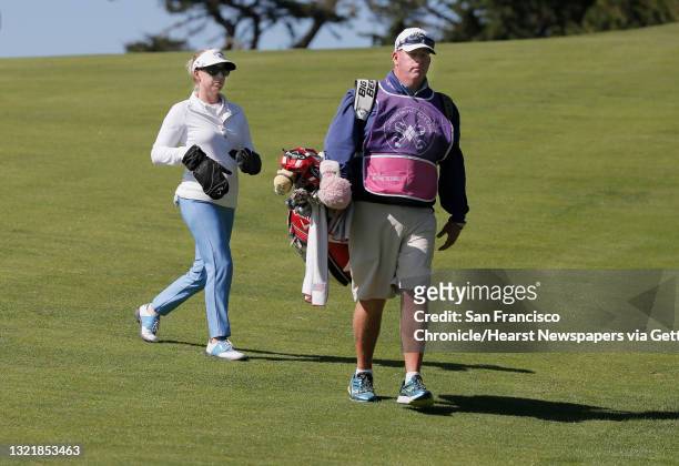 Morgan Pressel wears mittens to keep her hands warm as she makes her way to he drive on the seventeenth hole along with her caddie Barry "Rock"...