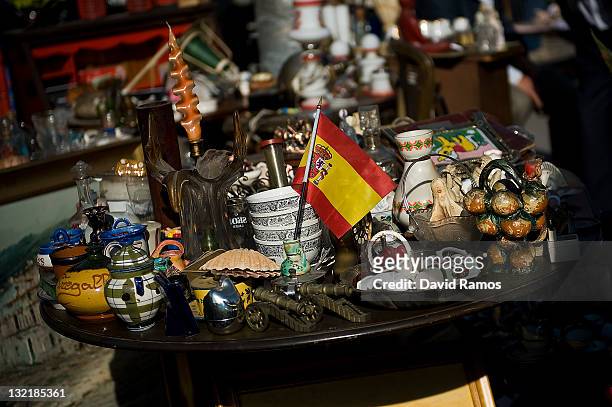Spanish flag stands among vases and utensils in a second hand furniture shop at a second hand market on November 9, 2011 in Barcelona, Spain. The...
