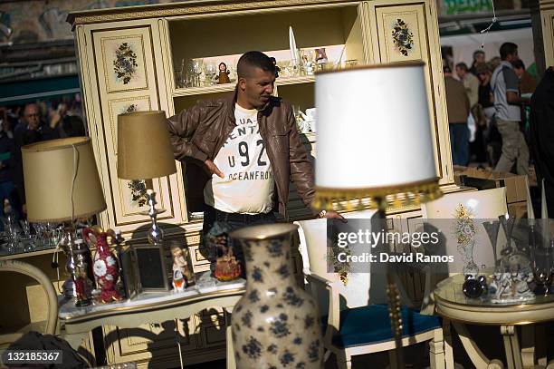 Vendor waits for customer at a second hand furniture shop at a second hand market on November 9, 2011 in Barcelona, Spain. The current Eurozone debt...