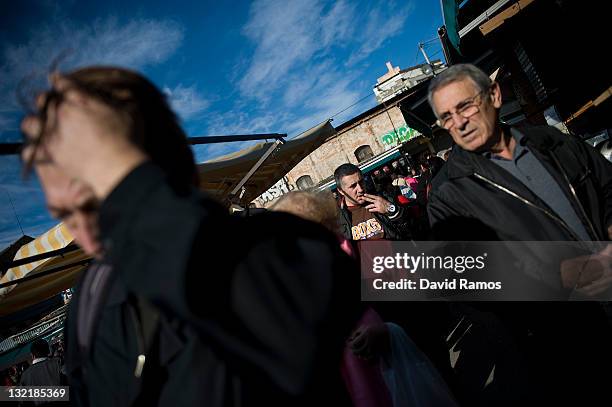 Customers walk at a second hand market on November 9, 2011 in Barcelona, Spain. The current Eurozone debt crisis has left Spain with crippling...