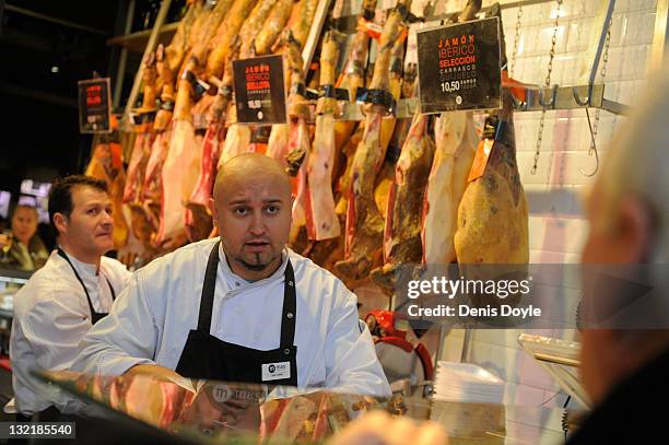 Worker tends to a customer at a Jamon Iberico stall at San Miguel market on November 9, 2011 in Madrid, Spain. The current Eurozone debt crisis has...