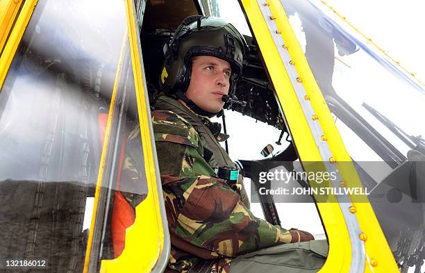 In a file picture taken on March 31, 2011 Britain's Prince William is pictured at the controls of a Sea King helicopter during a training exercise at...