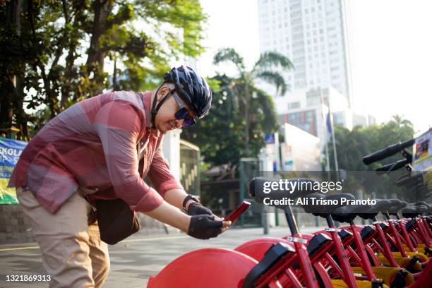asian man, bike to work, using bike sharing - bicycle rental stock pictures, royalty-free photos & images