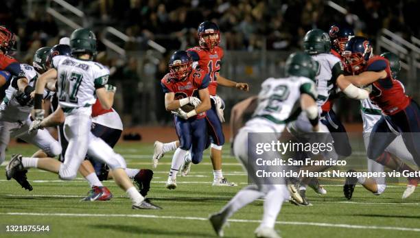 Campolindo's Matthew Ringquist, 34 looks for running room in the third quarter, as Campolindo Cougars take on the the Miramonte Matadors in Moraga,...