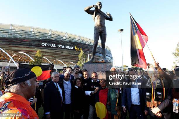 Gavin Wanganeen and Michael Long pose at the Nick Winmar statue following the Long Walk during the round 12 AFL match between the Essendon Bombers...