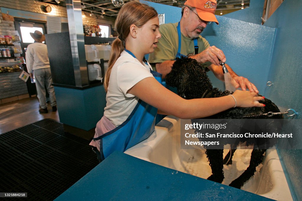 Mudpuppy_062_mac.jpg Jack Stuber and daughter Eliza, 11 take advantage of the dog washing stations that one can rent to wash their dog. "Max" gets a good cleaning at the new facility. They are from Albany. Taking your dog for a romp at Pt. Isabel in