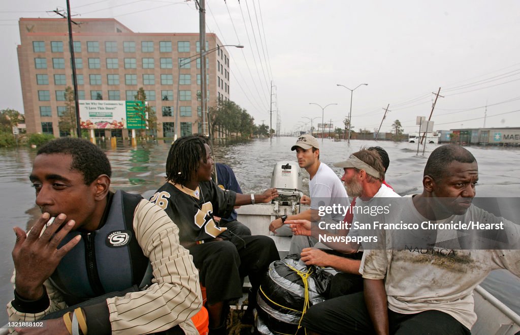 Katrina_235_mac.jpg Evacuation continued today with volunteers arriving with their own watercraft, pulling stranded people, like this boat full from the Airline Highway at I-10 Freeways, in Orleans Parrish near downtown. Chris Roy, volunteer,(on the
