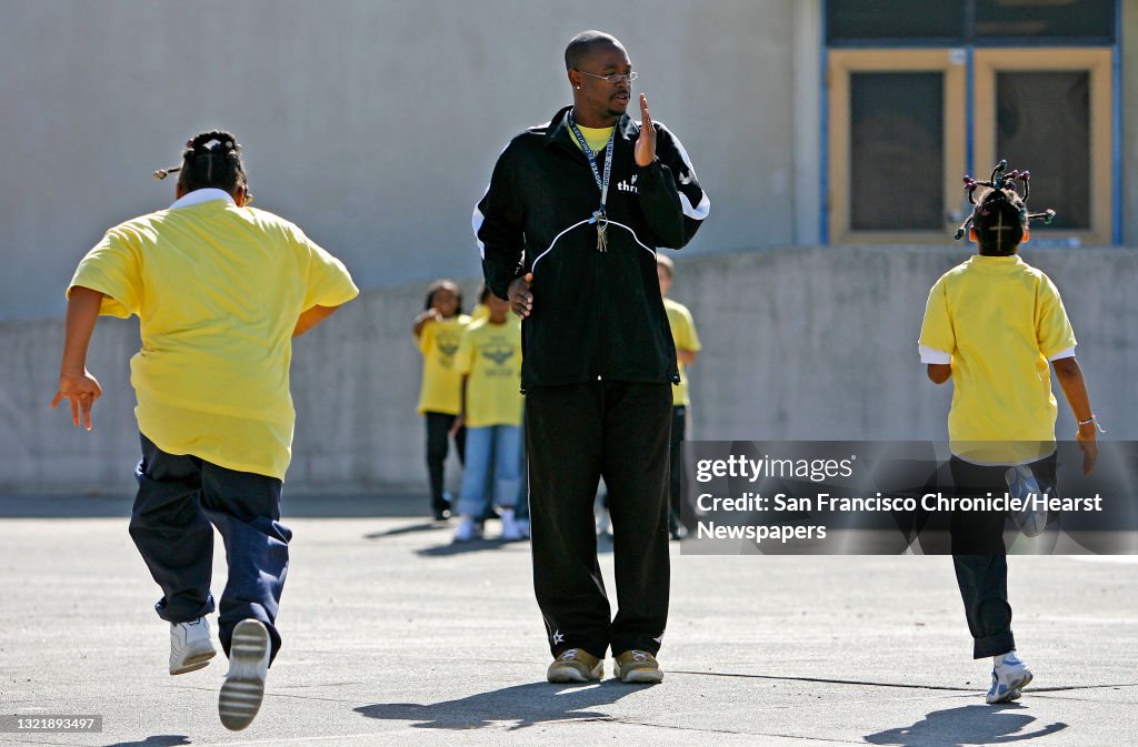 Reaching_back_071_mac.jpg Savannah Gable, n10 (left) and Desiree Gamble, 8 run through track drills for coach William Reliford Jr. Hoover Hawks Track Club, coached by 21 year old, William Reliford. 100 Black Men volunteers and students participating in