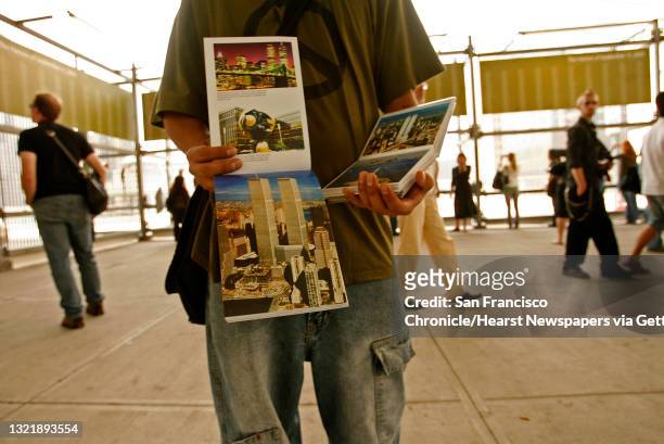 911nyc_06_094_mac.jpg What the locals call, "Terror Vendors", Mike, tries to sell books of postcards with the events from Sept. 11th, to visitors to...