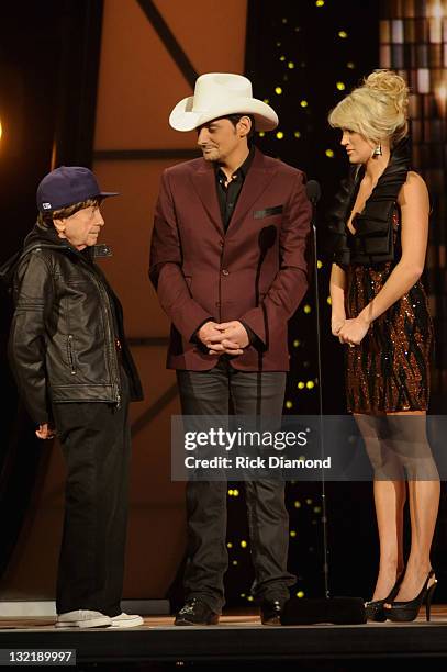 Little Jimmy Dickens, Brad Paisley and Carrie Underwood speak onstage at the 45th annual CMA Awards at the Bridgestone Arena on November 9, 2011 in...