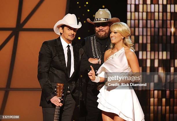 Hosts Brad Paisley and Carrie Underwood speak with Hank Williams Jr. At the 45th annual CMA Awards at the Bridgestone Arena on November 9, 2011 in...