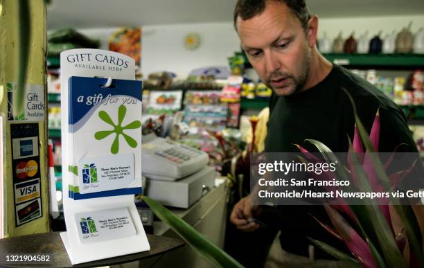 Ben rings up a sale near the Gift Card display at the check out counter. Three Bees owners Ben Kelley and his mom Dorcas McIntosh. Small businesses...