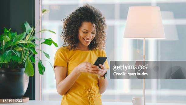 businesswoman in coworking space - looking at mobile phone stock pictures, royalty-free photos & images